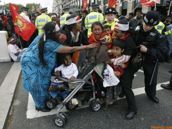 RNPS IMAGES OF THE YEAR 2009 - Pro-Tamil demonstrators scuffle with police after blocking a road in front of the Houses of Parliament in London May 18, 2009. Sri Lanka declared total victory on Monday in one of the world's most intractable wars, after killing the separatist Tamil Tigers' leader and taking control of the entire country for the first time since 1983.   REUTERS/Luke MacGregor (BRITAIN CONFLICT POLITICS IMAGES OF THE DAY)