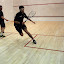Co-Captain, Jim Bristow (R) sends Santiago Imberston (P) to the back corner on his way to a win at the #3 position