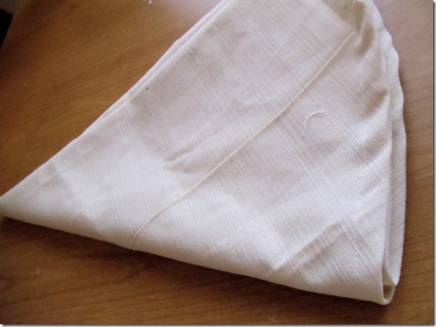 fold square of fabric in fourths