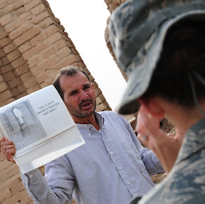 ALI BASE, Iraq Ð Dhaif Muhsen, Iraq Ministry of Antiquities curator for the Ur site, explains the history behind the oldest known standing archway in the world, located in the ruins of the ancient city of Ur, Feb.9.  The ancient Sumerian city of Ur was located in southern Mesopotamia, which is near An Nasiriyah in present-day Iraq.  Members of the 407th Air Expeditionary Group Chaplains Office offer three tours weekly of the Ziggurat and ruins of the city of Ur.  (U.S. Air Force photo/Staff Sgt. Christopher Marasky)