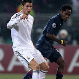 Real Madrid's Cristiano Ronaldo of Portugal, left,challenges for the ball with Lyon's Jean II Makoun of Cameroon during their Champions League round of 16 soccer match in group E, Tuesday, Feb. 16 , 2010, in Lyon stadium, central France. (AP Photo/Lionel Cironneau)