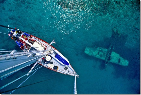 View from atop the mast of the private yacht Freydis as it passes by a sunken three-seat Japanese float plane from WW2, said to have been sunk by American aircraft while anchored in the Shortland group of the Solomon Islands. 

This picture was taken on a six-week trip by private sailboat through the seldom-visited islands north of New Guinea, in an area of the South Pacific known as the Solomon Sea.  Most of the islets here have no airport or regularly scheduled boat services, and their way of life is traditional by economic necessity.  
