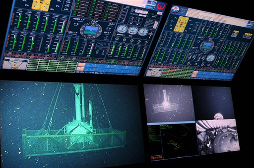 In this Tuesday, May 11, 2010 photo released by the U.S. Coast Guard, monitors show a small pollution containment chamber, known as the 'top hat,' is lowered into the Gulf of Mexico by the motor vessel Viking Poseidon. The chamber will be used in an attempt to contain an oil leak that was caused by the mobile offshore drilling unit Deepwater Horizon explosion. (AP Photo / U.S. Coast Guard, Petty Officer 3rd Class Patrick Kelley)