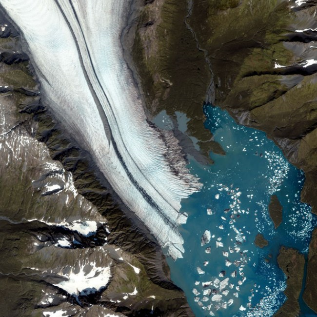 Bear Glacier in Alaska, 2006: The hue is caused by the silt that is finely ground away from the valley walls. The stripes down the middle are formed from rocks and debris when two glaciers merge.  In 2008 the lake broke through and drained into Resurrection Bay.