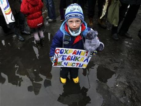 A boy stands with a poster reading 'Let's Keep Baikal Clean' during a demonstration of protest in St.Petersburg, March 27, 2010. Credit: Reuters / Alexander Demianchuk