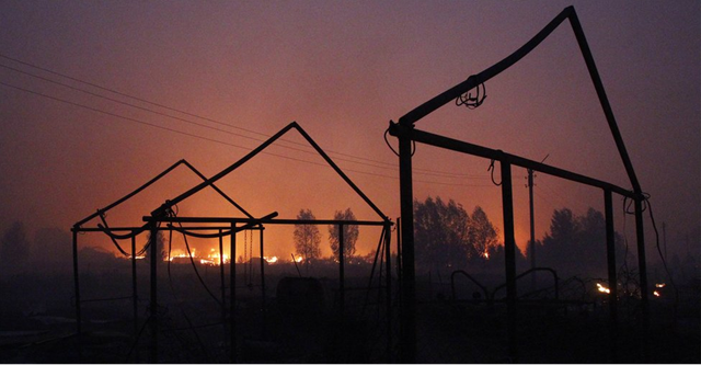 In the village of Vyksa, in Nizhny Novgorod region, residents have watched helplessly as their homes burn down, 30 July 2010. BBC