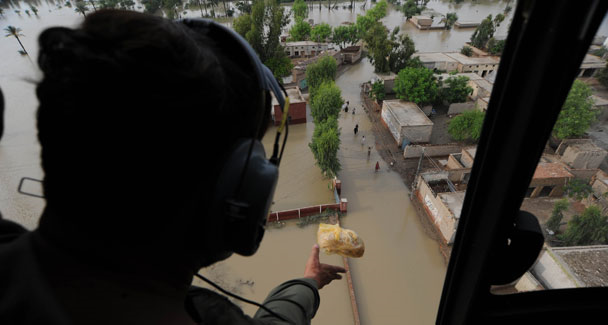 A Pakistani army soldier drops food bags for flooded survivors in Kot Addu, in the southern province of Punjab on August 8, 2010. AFP