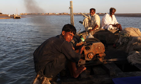 Pakistani fishermen on the Indus delta at dusk. Fish catches have increased dramatically since the 2010 floods. Photograph: Declan Walsh / guardian.co.uk