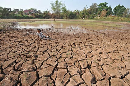 A severe drought in Southeast Asia and southern China has caused the Mekong River to drop to a 50-year low. Here, a farmer's son sits on a drought-hit rice field in the suburbs of Vientiane, the capital city of Laos, March 2010. Hoang Dinh Nam / AFP / Getty Images / aolnews.com