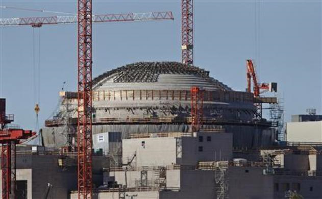 Construction cranes rise over the reactor dome of the Olkiluoto 3 nuclear power plant which is being built on Finland's west coast near Rauma, about 220 kms (136 miles) northeast of Helsinki, in this September 28, 2010 file photo. Credit: REUTERS / Bob Strong / Files