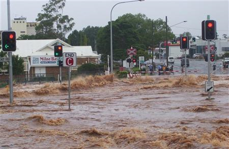 Flash floodwaters cover a street in Toowoomba, Queensland January 10, 2011. Residents of low-lying parts of Australia's third largest city, Brisbane, sandbagged their homes against rising waters on Monday as torrential rain exacerbated record floods that have paralysed the coal industry in the northeast and now threaten tourism. REUTERS / Daniel Breeze