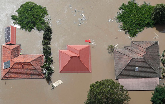 Aerial view of flooded houses in Australia, 14 January 2011. Note the solar panels on rooftops at left. amazingonly.com