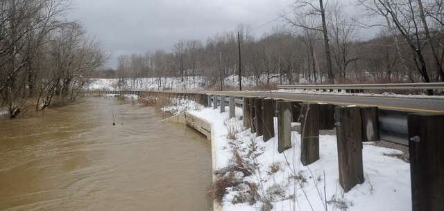 High water approaches Ohio 93 at a bridge near Houts Road in Muskingum County. High water could affect area travel. Nick Krupa, operations manager for the Muskingum Area Office of the U.S. Army Corps of Engineers, said river gauges Friday morning gave no indication that dam gates at Dover, the Mohawk on the Walhonding or at Wills Creek should begin using flood control measures, but will remain open. Trevor Jones / Coshocton Tribune