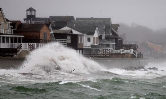 The sea wall in Scituate, Massachusetts has been hit hard by storms that pose an increasing threat, like one that recently sent waves crashing in. Jonathan Wiggs / Globe Staff