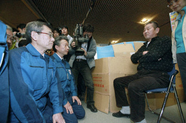 TEPCO officials apologize to Fukushima evacuees. Masataka Shimizu (L front), president of Tokyo Electric Power Co., and other company officials apologize on April 22, 2011, to residents of the village of Kawauchi and town of Tomioka in Fukushima Prefecture, who are staying in Big Palette Fukushima, a convention hall in Koriyama, after being forced to leave their homes near the company's crisis-stricken Fukushima Daiichi Nuclear Power Station. Pool photo / Kyodo