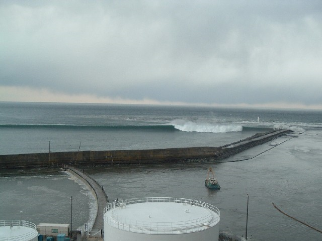 Tsunami wave approaches the Fukushima Daiichi Nuclear Power Station, 11 March 2011. The location is the slope at the eastern side of Radioactive Solid Waste Storage Facility (The east side of Unit 5 taken from the southern side of the unit). TEPCO