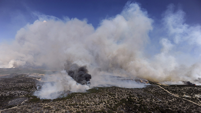 Smoke rises in the air as wildfire in Coke County, Texas, burns on Monday afternoon, 18 April 2011. The Abilene Reporter-News / Tommy Metthe