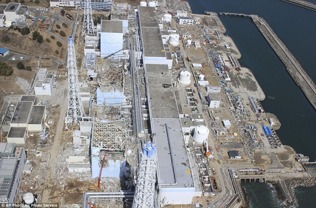 Aerial view of the ruins of the Fukushima Daiichi nuclear plant, 30 March 2011. From top to bottom, reactors one to four. AP Photo / Air Photo Service / dailymail.co.uk