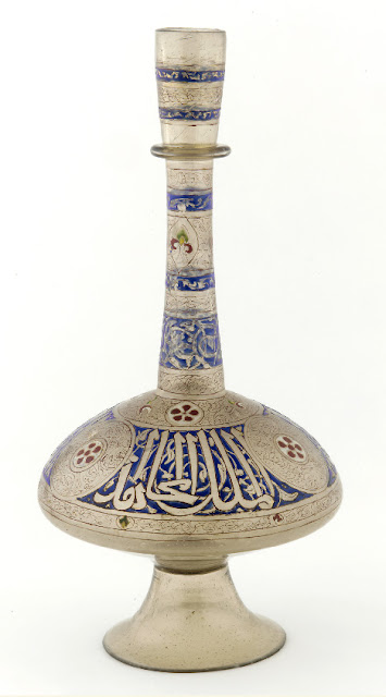 Inscribed along the widest part of this bottle in thuluth script is the Arabic phrase, "Glory to our master, the sultan, al-Malik, al-Mujahid, the wise, the just." Syria. Mid-14th century. 47.9 x 24.8 cm. Thuluth script. Courtesy of the Freer Gallery of Art, Smithsonian Institution.