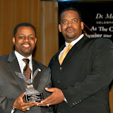 Kwame accepts award from James Speight III, President & CEO