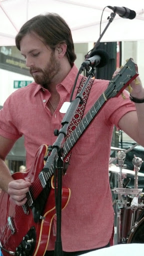 Caleb tunes his guitar for the next song