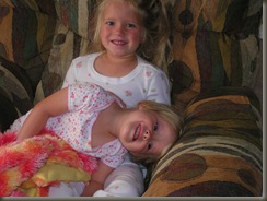 11.23.08 Brynn and Alise in the morning watching tv...it hurts to smile