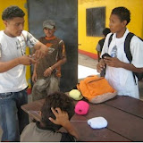 Marvin the sports instructor teaching bracelet making to a boy just back from school