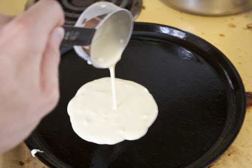 Batter being poured onto hot pan