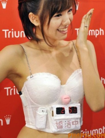 Japan's lingerie maker Triumph International Japan campaign girl Hiromi Nishiuchi displays the "Konkatsu Bra" or "Husband hunting Bra" at the company's headquarters in Tokyo on May 13, 2009 to encourage women to hunt husband and buck the trend of women marriage late and staying single in Japan.  The bra has a marriage countdown clock and when she inserts her engagement ring in the heart-shaped ring rest affixed between the cups it stops the clock and plays a wedding song.    AFP PHOTO / Yoshikazu TSUNO (Photo credit should read YOSHIKAZU TSUNO/AFP/Getty Images)