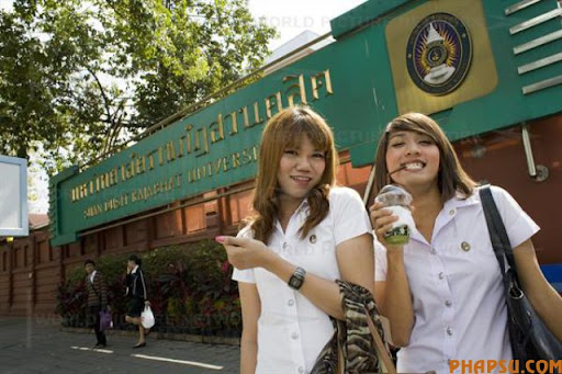 Wittaya Jannoi (21) a marketing student and Watchara Sathongpein (21) a general management student, in front of the entrance of Suan Dusit university.In Suan Dusit University in Bangkok, ladyboys feel free to be themselves by getting dressed in girls' uniforms and behaving in a feminning way. The University's policy of accepting them as equal to other students, has made it so popular that it now has about 100 transgender students studuing in it's faculties.  8 January 2009. Bangkok, Thailand