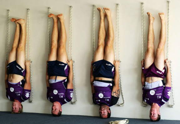 MELBOURNE, AUSTRALIA - JUNE 22:  Melbourne Storm players  perform a yoga exercise during a Melbourne Storm NRL recovery session at Bridge Road Yoga Studios on June 22, 2009 in Melbourne, Australia.  (Photo by Mark Dadswell/Getty Images)
