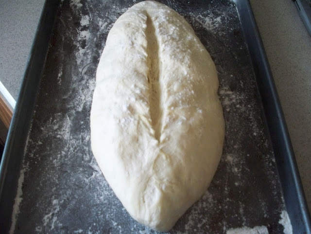 Use a lame or single-edge razor to slice the dough.
