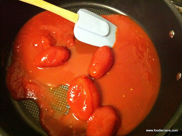 stir chopped tomatoes with olive oil in saucepan