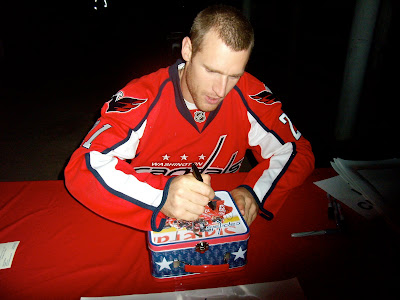 Signing the lunch box. I must say his signature is rather large!