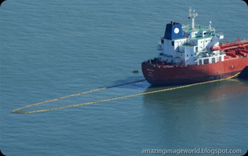 Oil boom extends from the tanker001