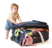 Baby standing near the suitcase Baby standing near the suitcase