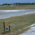 PB301900.JPG, The Cocos golf course. The white triangular markers designate the boundary of the runway, which the golf course crosses. For obvious reasons, the course is not open for play on days when an airplane is expected., Cocos
