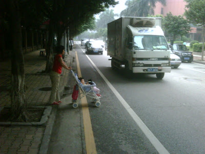 Baby in the street Woman with baby in street