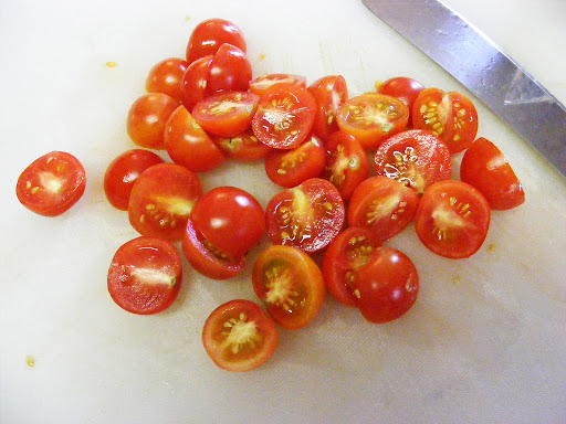 Cut a pint of cherry tomatoes in half.