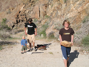Getting rocks to anchor down the tents.