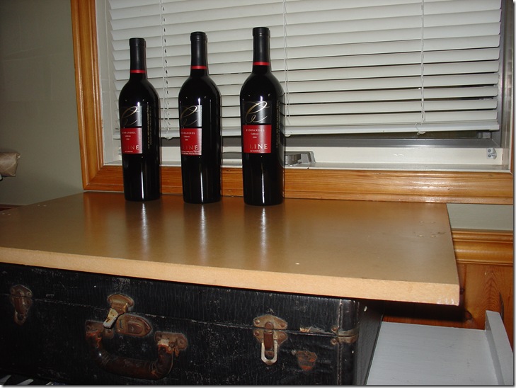 Low shelves + suitcase + wooden board = temporary drinks station!
