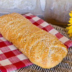 Stromboli with Olives, Sun-Dried Tomatoes, Ham, Salami, and Cheese