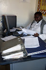 Accountant Kalambo checking LinkNet books