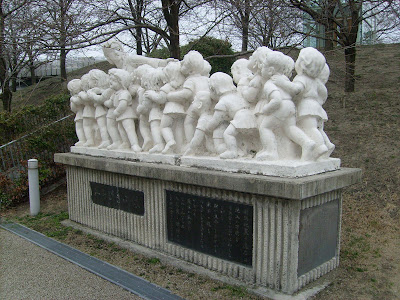 Statue of a teacher and unruly kids outside the culture center.