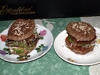 Double decker burgers with avocado, greens, quinoa sprouts, nut butter and marinated onions.