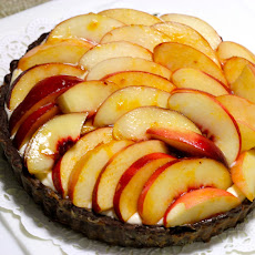 Mascarpone Mousse in Chocolate Tart decorated with Peaches marinated in Peach Liqueur