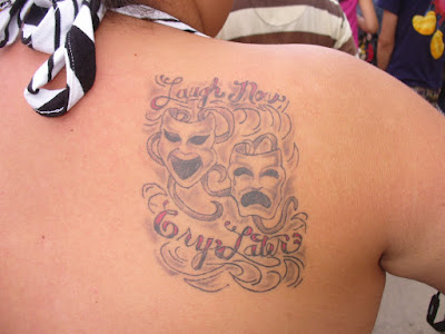 A tattoo that reads 'Laugh Now, Cry Later.' at 9:02 AM
