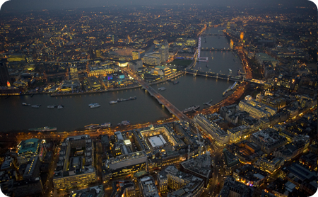 Waterloo Bridge and the River Thames, also featuring the London Eye (center, seen from the side), the Royal National Theatre, and Waterloo Station. (© Jason Hawkes)