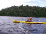 Isabella paddling down river.