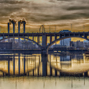 The Mood Through the Third Avenue Bridge by Bill Tiepelman - Buildings & Architecture Bridges & Suspended Structures ( water, st. anthony falls, structure, smoke stack, state highway 65, third avenue bridge, reflections, stone bridge, transportation, landscape, city, geometry, landmark, grunge, minnesota, industrial, mississippi river, minneapolis, concrete bridge, moody, lines, bridge, commercial )